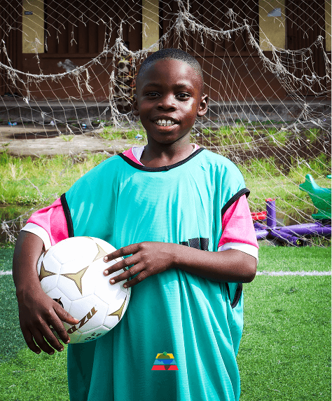 Young football player holding a ball